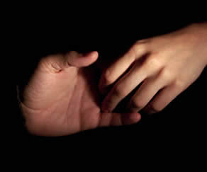 Two hand rouching one another with dark background